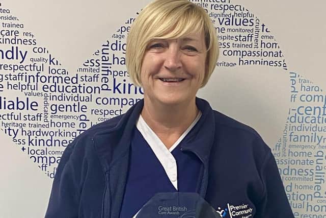Marie Brown collecting her award from Premier Community's HQ.