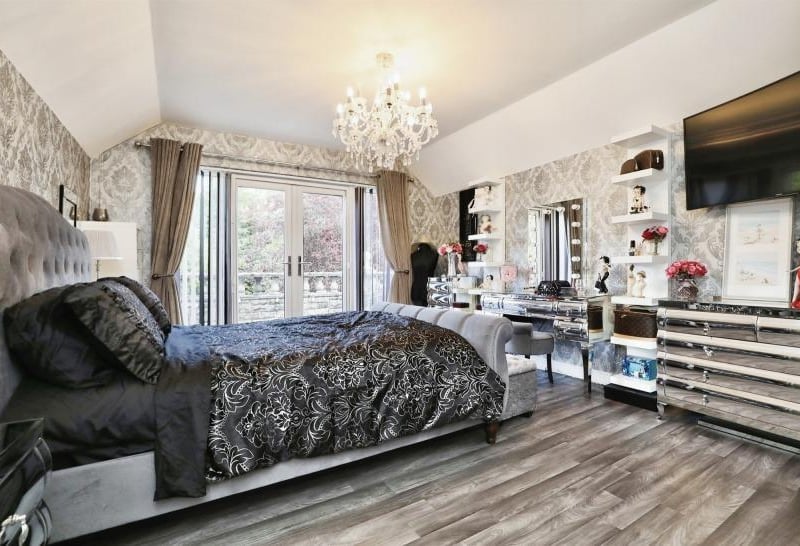 One of many elegant bedrooms at the Firbeck estate. This one has built-in wardrobes, and patio doors leading out on to a balcony overlooking the back garden.