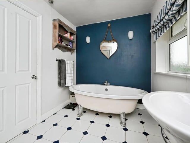 The family bathroom includes a rolled-edge bath, separate shower cubicle, pedestal wash hand basin, and WC.