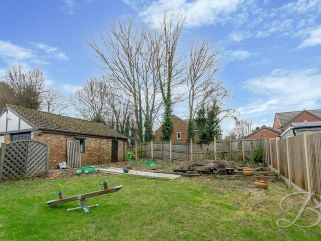 The back garden is private and enclosed. To the left, you can see the garage.