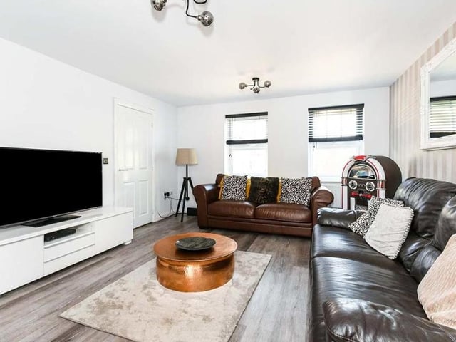 The lounge at the £390,000-plus Kirkby home is both spacious and welcoming, with double-glazed windows overlooking the front of the property. LVT (luxury vinyl tile) flooring adds to the appeal of the room, which also has double doors leading to the dining kitchen.