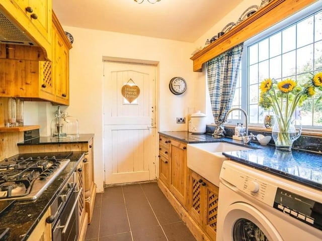 Next stop is the rustic, cottage-style kitchen, which is fitted with wood wall and base units, and granite worktops incorporating a ceramic Belfast sink. Appliances include a gas hob, electric oven and discreet extractor fan, while there is space and plumbing for a washing machine.