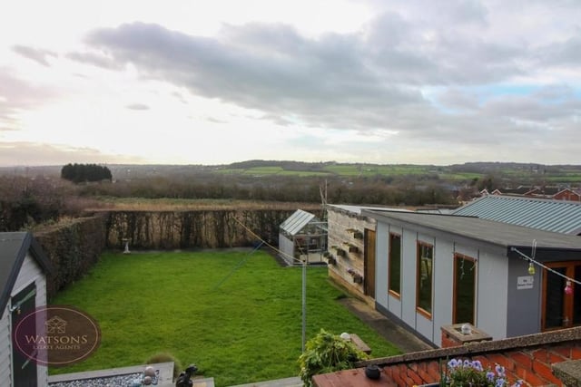Before we go any further, let's take a look at those spectacular views over open fields that estate agents Watsons are raving about. To the right is the back garden's summer house which is also a major selling point for the bungalow.