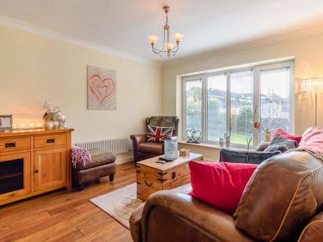 Moving now into the comfortable lounge, which is a good size and boasts a large floor-to-ceiling, double-glazed window overlooking the front of the property.