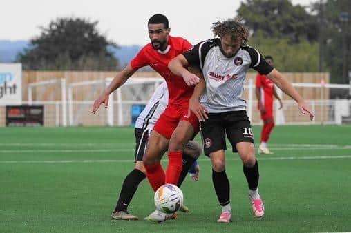 Goal scorer Mikey Williams battles for possession