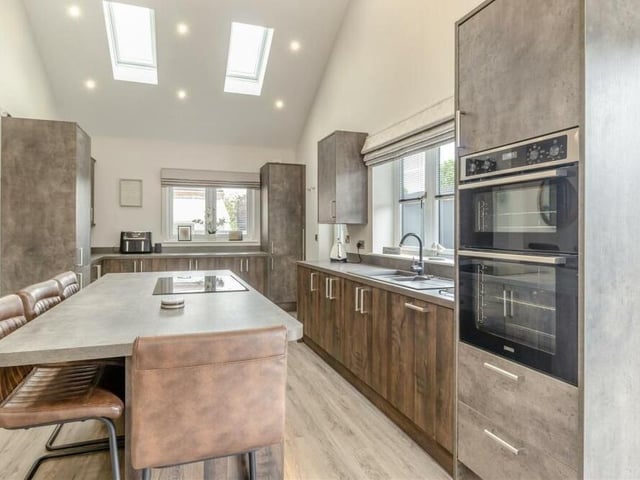 Integrated appliances within the kitchen include a double oven, dishwasher and fridge/freezer. There is also an inset one-and-a-half-bowl sink with drainer and mixer tap, plumbing for a washing machine and LVT flooring.