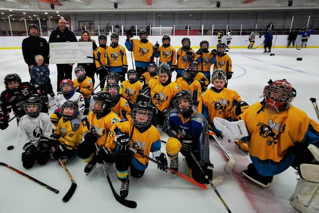 Anna Grabas, financial accountant at Mansfield Building Society, and members of the Sutton Sting Ice Hockey Academy