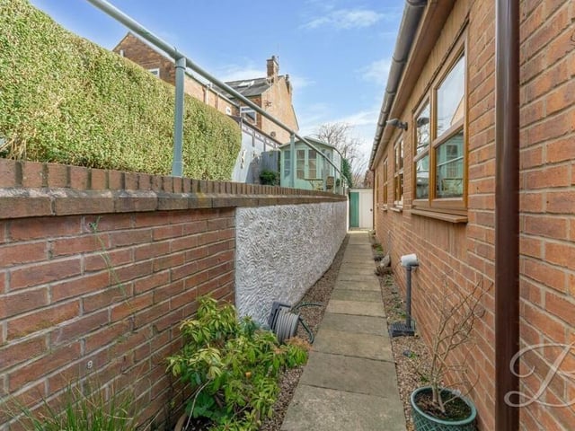 Gates at the front of the house lead you towards the landscaped rear garden.