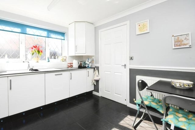 A second view of the kitchen, which includes many of the appliances you need. There is space too for a breakfast table, while the door leads to a utility room.