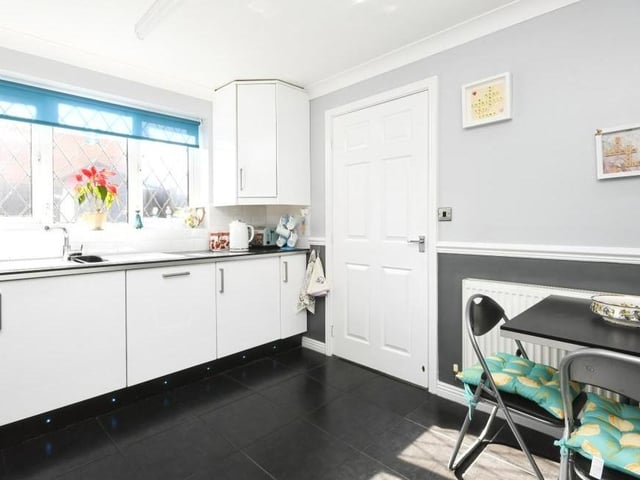 A second view of the kitchen, which includes many of the appliances you need. There is space too for a breakfast table, while the door leads to a utility room.