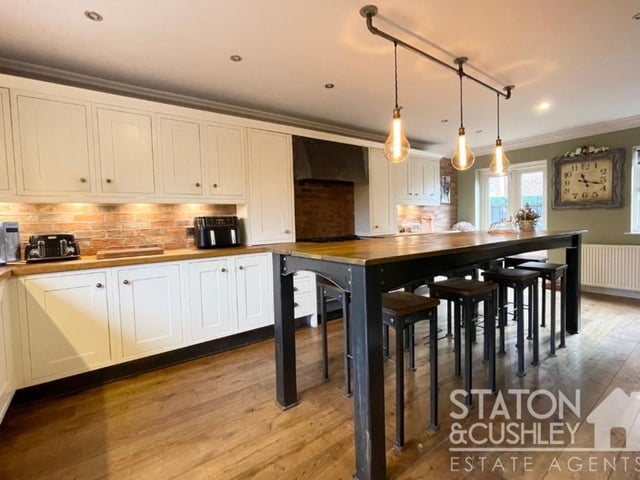 At the heart of the kitchen is a breakfast island with steel legs and a solid oak worktop.