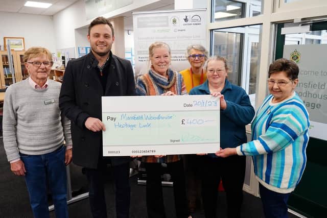 Ben Bradley presented a cheque to Mansfield Woodhouse Heritage Link at the library.