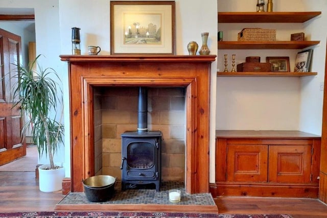 The fireplace in the living room is just one of the many traditional features that are scattered around the cottage.
