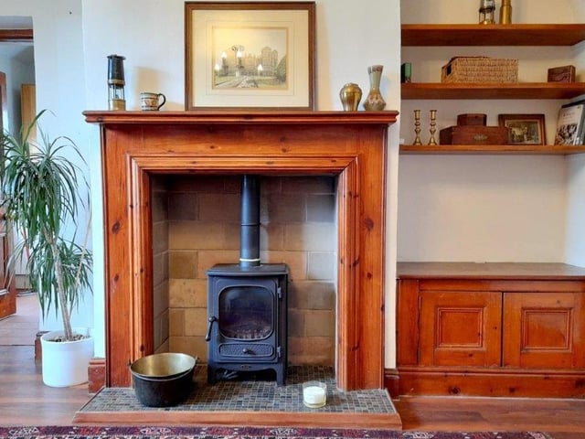 The fireplace in the living room is just one of the many traditional features that are scattered around the cottage.