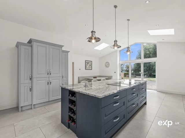 The spectacular kitchen diner is a visual delight with its on-trend central island and additional informal dining space in front of the bi-folding doors that lead outside.