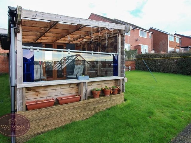 A second view of the relaxing retreat that is the covered, decked seating area in the garden of the £325,000 bungalow. It has direct access to the summer house.