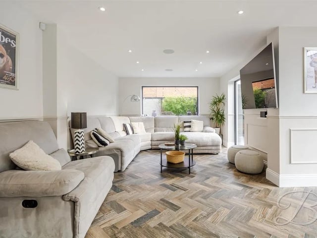 The open-plan dining and sitting area offers a generous layout, allowing for a variety of furniture arrangements to suit your personal style.