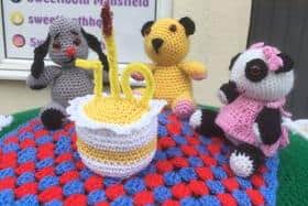 Sooty, Sweep and Sue made by Debbie Wiliamson pictured on top of the red postbox