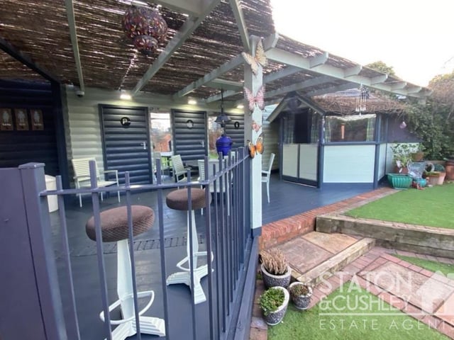 The summer house boasts a balcony-type area, with space for seating, where you can overlook the beauty of the back garden.