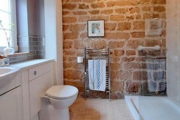 Here is the en suite to the main bedroom. It comprises shower cubicle, wash hand basin and low-flush WC.