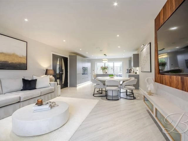 The open-plan kitchen, dining and living area forms a stylish and sociable heart of the home, perfectly suited to modern living.