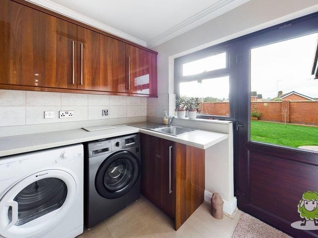 A useful addition to the ground floor is this laundry room or utility room. It is fitted with a full range of units and has space and plumbing for both a washing machine and tumble dryer. There is also access to the garden and the double garage.
