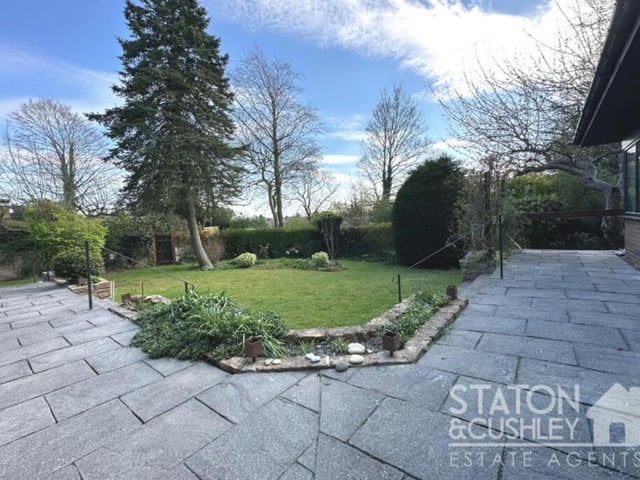 A pathway and lawn form part of the garden.