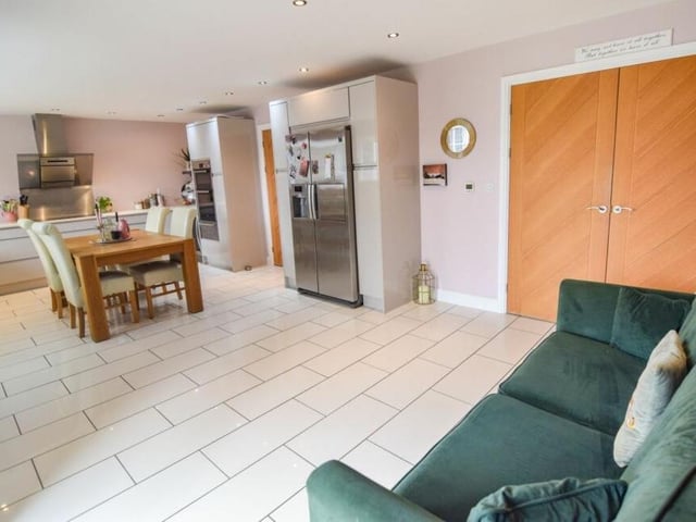 Here is our first look at the open-plan kitchen/diner with living area. The kitchen includes an American-style fridge/freezer.