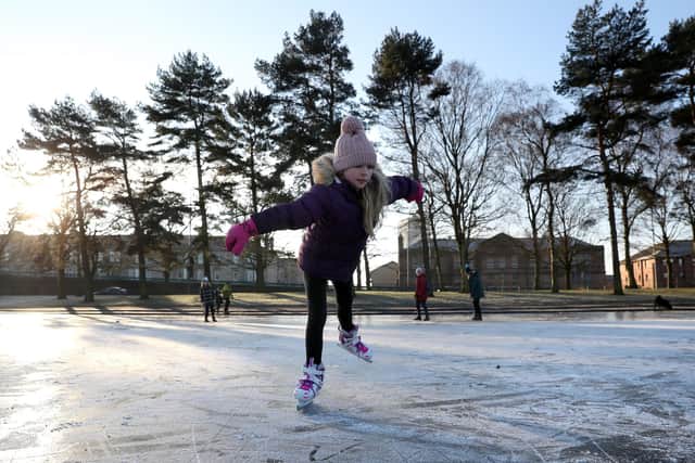 Isla Rose (9) skates on a frozen pond at Victoria Park in Glasgow.