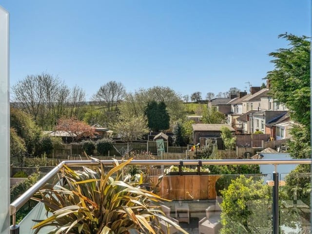 A view from the bedroom balcony, showing the rural expanse of the surrounding countryside.