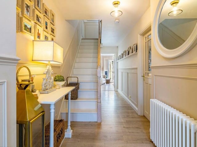 As we prepare to check out the first floor, let's pass through the entrance hall to get to the staircase. An attractively presented space, it boasts under-stairs storage, a wood-effect laminate floor and doors to all the main ground-floor rooms.