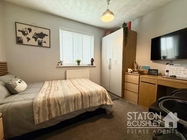 The master bedroom benefits from fitted wardrobes and a private en-suite shower room