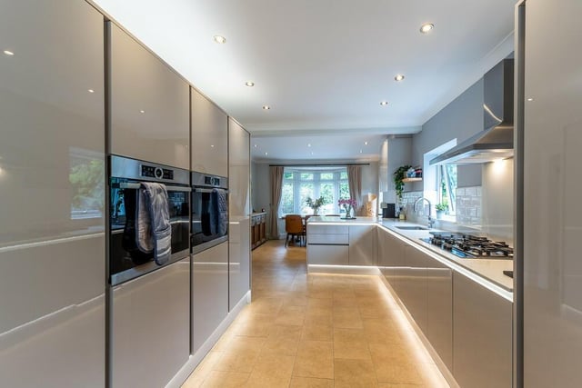 This image underlines the length of the sparkling dining kitchen, with its bay windows at each end and two ovens. It is a fantastic space in which to cook, relax and enjoy.