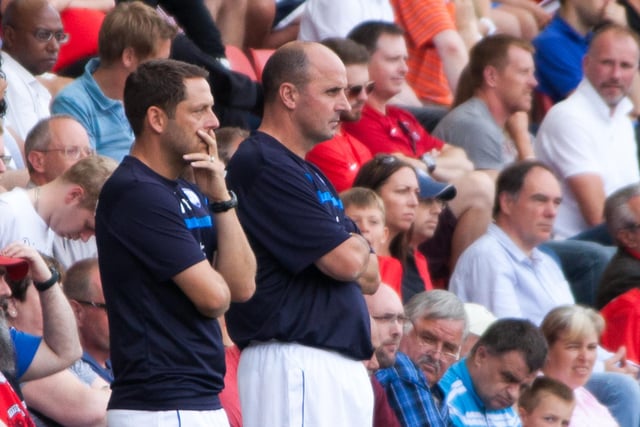 Paul Cook and assistant Leam Richardson watch the action unfold against Leyton Orient on August 9 2014.