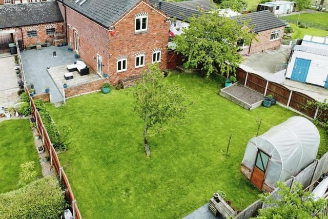 We close our gallery with a revealing aerial shot of the south-facing rear garden, which is made up of fruit trees and a large lawn.