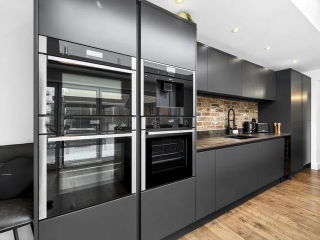 The kitchen is fitted with high-quality finishes including neff appliances, featuring twin ovens, a microwave combi oven, and an integrated coffee machine. Additional premium features include an induction hob with integrated extractor and stylish Dekton worktops.