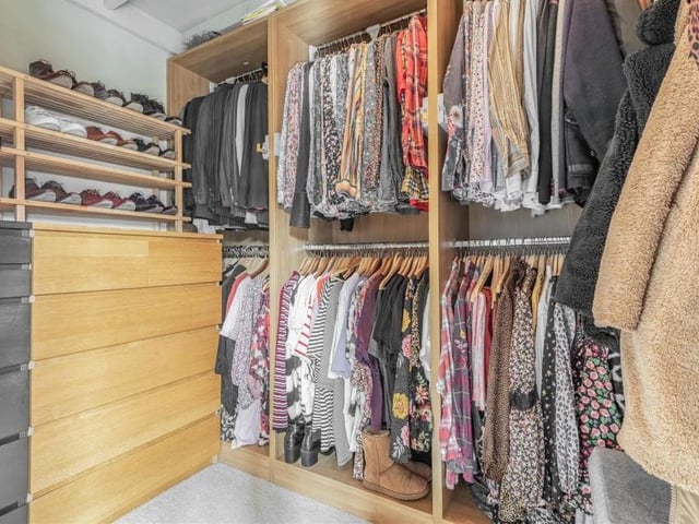 The master bedroom also includes this walk-in wardrobe, which has space for even the most extensive of clothes collections! It even has a useful mezzanine floor above.