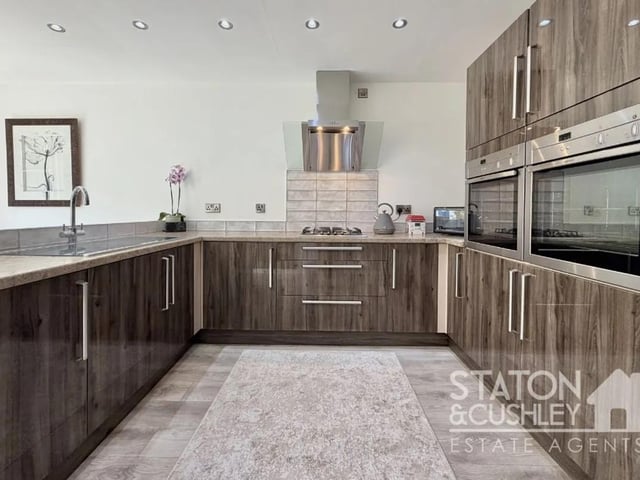 Designed with both entertaining and family life in mind, this outstanding space features a high-specification fitted kitchen complete with a comprehensive range of quality integrated appliances, including a fridge/freezer, dishwasher, washing machine, tumble dryer, twin ovens, and a gas hob