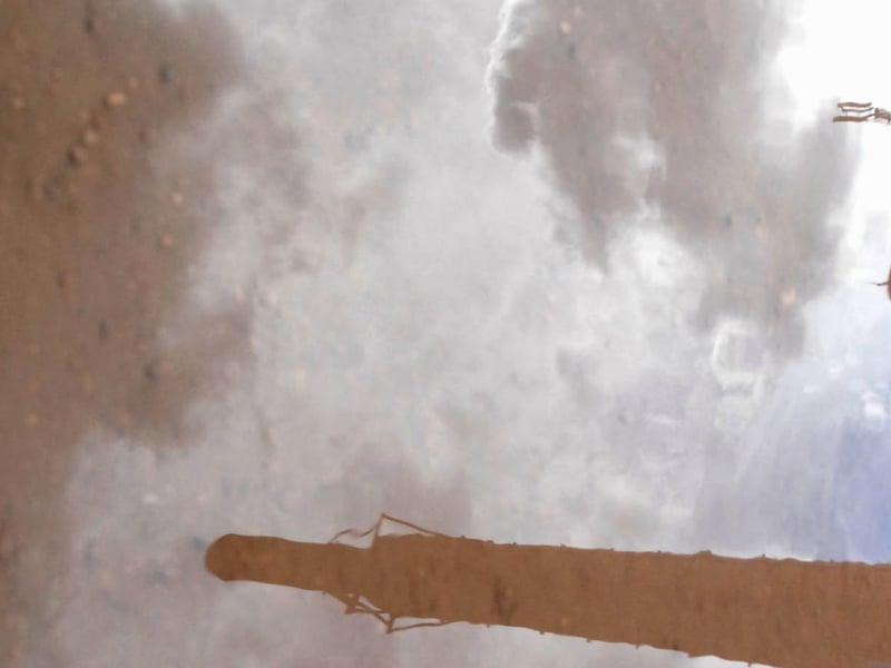 Former Mansfield brewery reflected in a puddle. 2008.