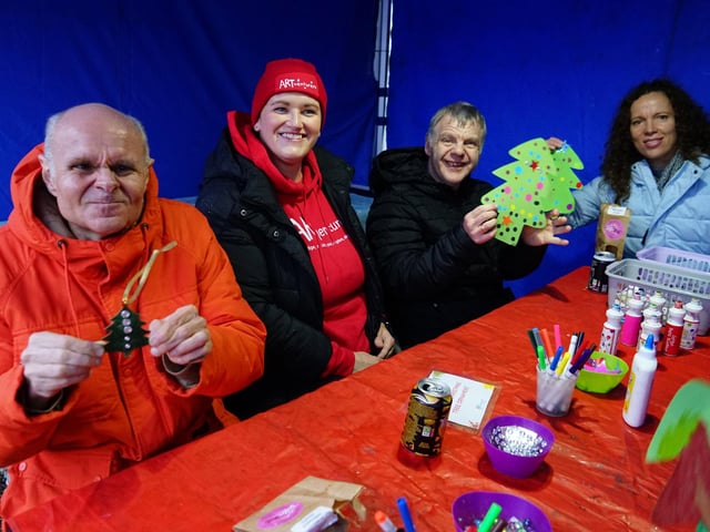 Stacey Lerase from Art Venturers helping residents from Corner House make decorations.