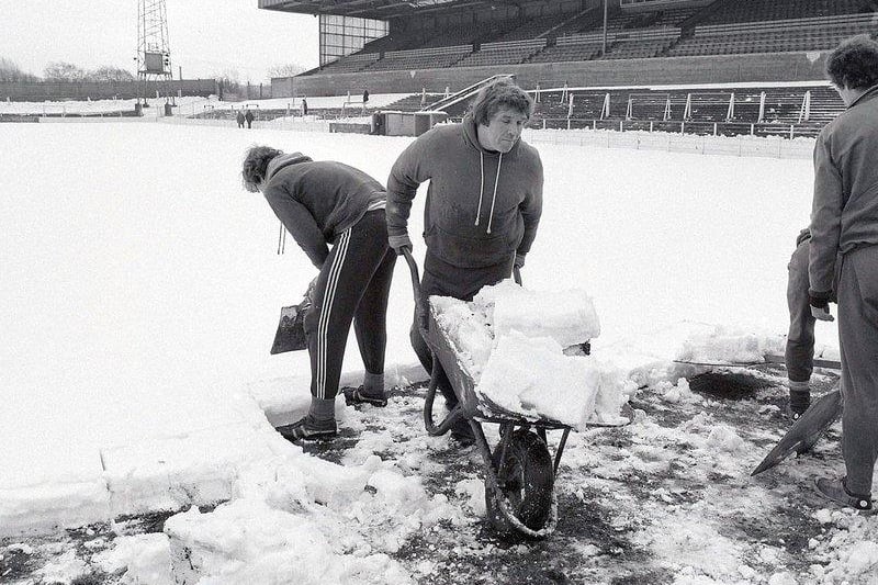 Stags players and staff clear snow from the pitch at Field Mill in 1979.