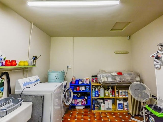 The external outbuildings at the Crow Hill Drive property include this laundry room.