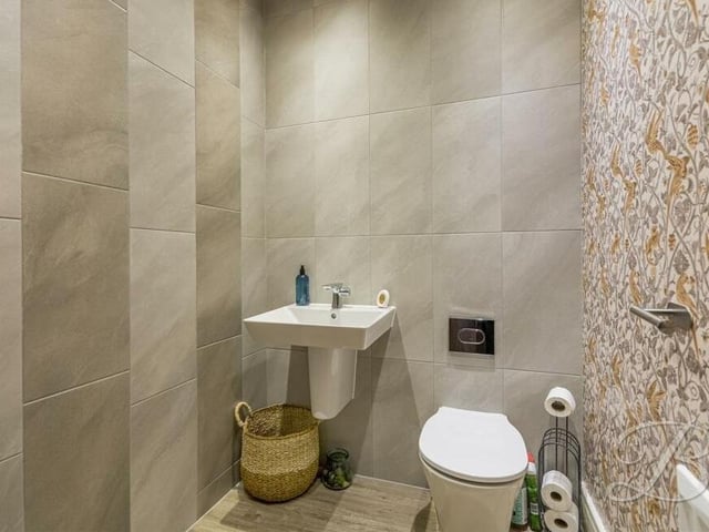 The downstairs toilet at the £490,000-plus property includes a hand wash basin and a low-flush WC.