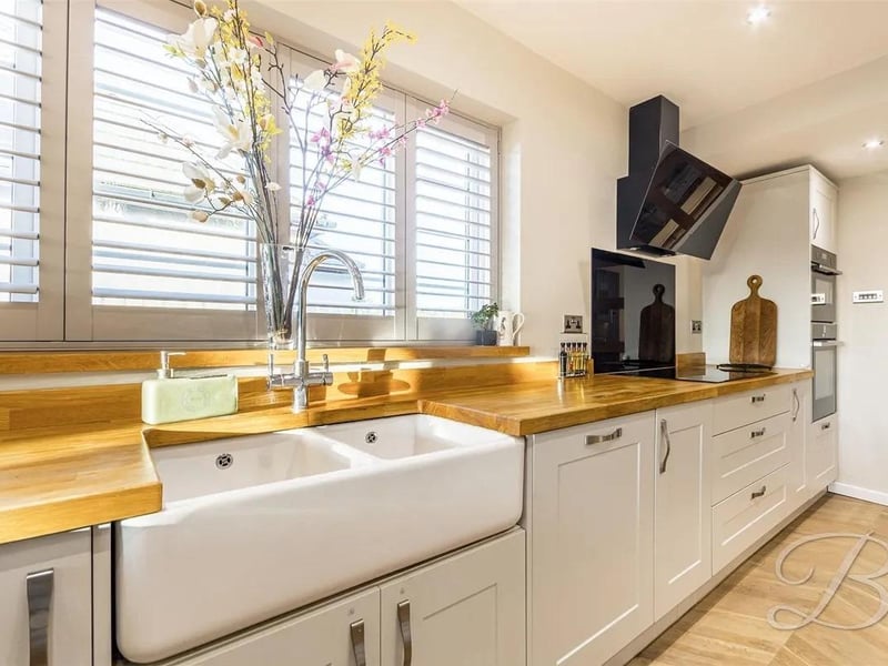 The kitchen is complete with a range of high end cabinetry and worktop units, double belfast sink and all essential integrated appliances.