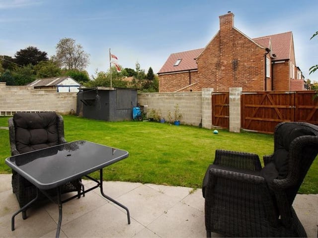 This pleasant patio-type area offers another option to relax with a cup of coffee or glass of wine. It is part of the property's large wraparound garden.