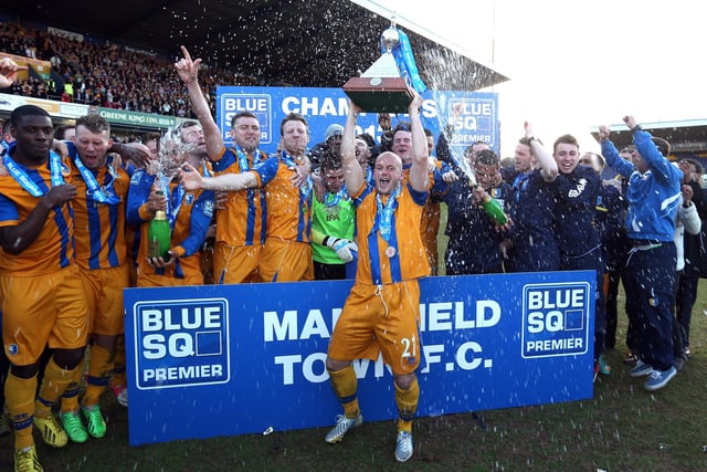 Adam Murray lifts the trophy as Mansfield celebrate promotion back to the Football League on April 20, 2013.