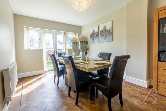 Fine dining is guaranteed in this delightful room. The table is set and French doors, which lead outside, let in lots of natural light.