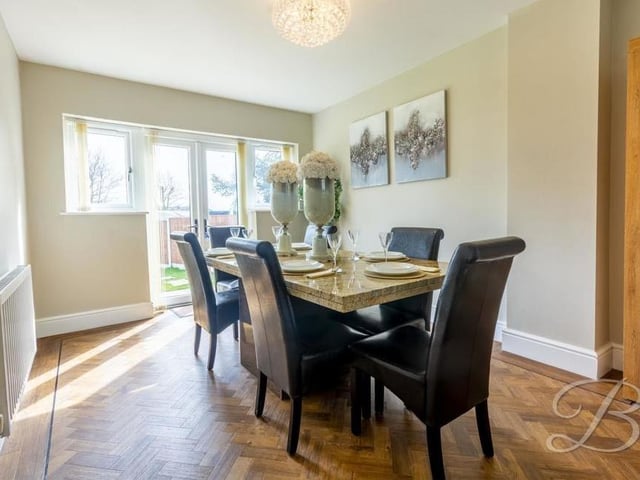 Fine dining is guaranteed in this delightful room. The table is set and French doors, which lead outside, let in lots of natural light.