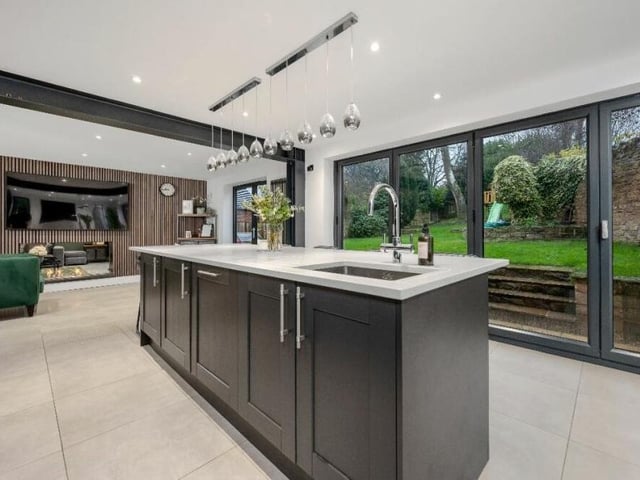 Here you can see how the second reception room flows into the magnificent kitchen, which includes large, aluminium bi-folding doors that lead out to the back garden.