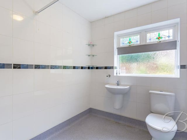 The shower room or wet room at the Kirkby bungalow. It comes complete with a three-piece suite, including wash hand basin and WC.